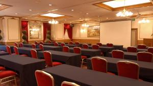 a conference room with tables and red chairs at APA Hotel Kochi in Kochi