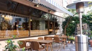 a restaurant with tables and chairs in front of a building at APA Hotel Kochi in Kochi