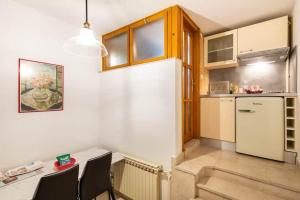 eine Küche mit einem Tisch und einem weißen Kühlschrank in der Unterkunft Peace near the city center in Zagreb