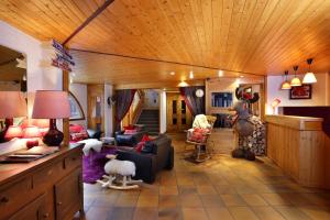 a living room with a couch and animals on the floor at Hôtel du Bourg in Valmorel