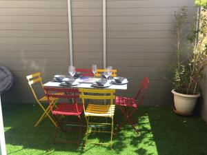 a table with chairs and wine glasses on a patio at Superbe 120m2 au Suquet - Property With Style in Cannes