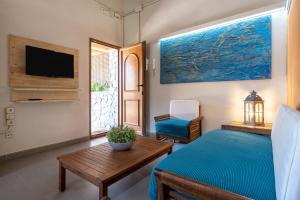 a bedroom with a bed and a tv and a table at El Clos 4 in Conesa