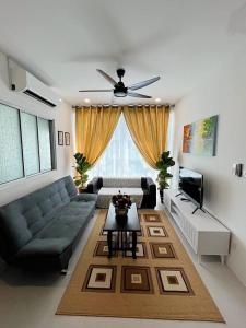 a living room with a couch and a table at Aina Staycation, Metrocity in Kuching