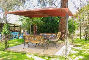 a patio with a table and chairs under an umbrella at Nyahururu Highlands Heaven -BnB in Nyahururu