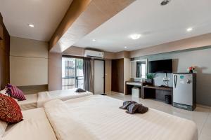 a large living room with a couch and a refrigerator at Latin Garden Hotel in Bangkok +66 photos