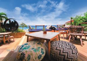 a wooden deck with tables and chairs and the ocean at Fairways and Bluewater Boracay in Boracay