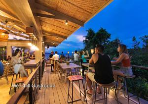 a group of people sitting at tables on a deck at Fairways and Bluewater Boracay in Boracay
