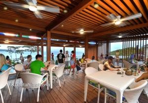 a restaurant with people sitting at tables on a deck at Fairways and Bluewater Boracay in Boracay