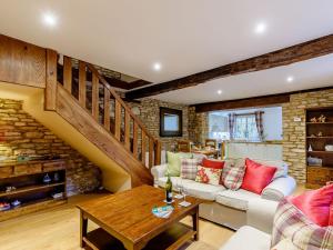 a living room with a couch and a table at Kilcot Coach House in Hillsley