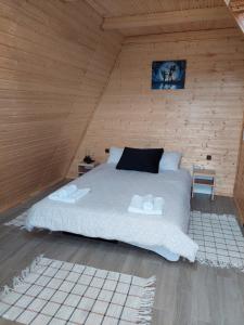 um quarto com uma cama grande num quarto de madeira em Stelele Coziei em Valcea