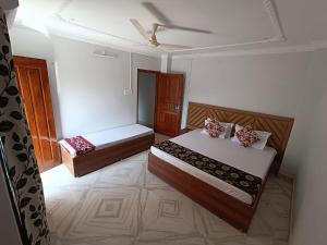 a bedroom with two beds and a ceiling fan at Mi Casa Homestay in Guwahati