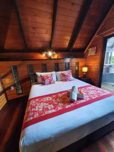 a bedroom with a large bed in a room with wooden walls at Sokala Villas in Muri