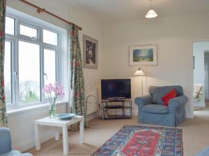 a living room with a chair and a television at Sunray - Uk31515 in Dale