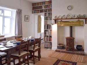 a dining room with a table and a fireplace at Sunray - Uk31515 in Dale