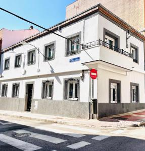 a white building on the corner of a street at Villa Verde in Madrid +44 photos