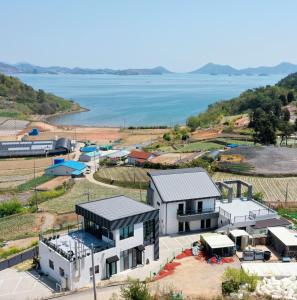 an aerial view of a house next to the water at Secret Garden Pension in Yeosu