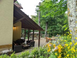 a patio with couches and tables in a garden at Forest in Dilijan