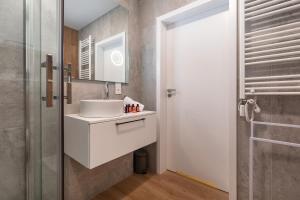 a bathroom with a white sink and a shower at Pobierowo Plaża & SPA - Apartament na Wydmach by Renters in Pobierowo