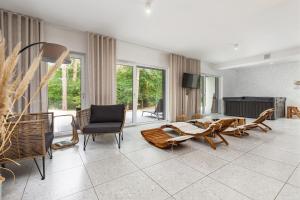 a living room filled with furniture and a fireplace at Pobierowo Plaża & SPA - Apartament na Wydmach by Renters in Pobierowo