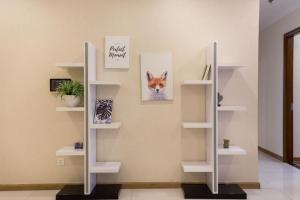 a room with white shelves with a picture of a fox at Landmark Plus - Vinhomes AirBnb in Ho Chi Minh City