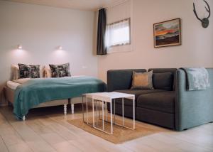 a living room with a couch and a table at Heima Holiday Homes in Selfoss