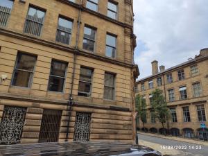 a building with a car parked in front of it at Sky Apartments in Bradford