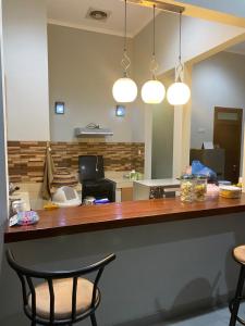an office with a desk with a phone and two chairs at Villa Syamsu in Bukittinggi