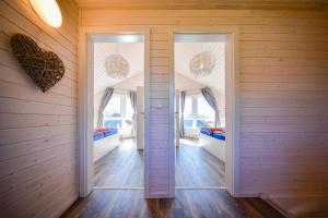 two doors in a room with two beds at Nordic Ferienpark Sorpesee (Sauerland) in Sundern
