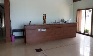 a large wooden counter in a room at Daffodil Inn in Velankanni