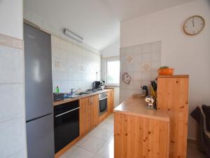 a kitchen with a sink and a stove top oven at Apartments Jaklin in Rab +25 photos