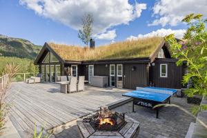 a house with a grass roof with a fire pit at Libehi in Lona