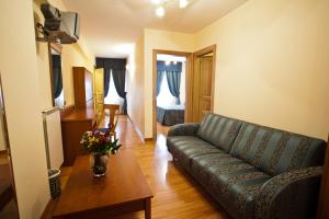 a living room with a couch and a table at Albergo Lo Scrigno in Pescocostanzo