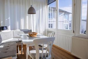 a living room with a table and chairs and a couch at Villa Meeresblick in Sassnitz