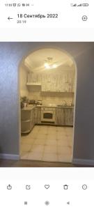 a picture of a kitchen with an archway at Квартира для семьи in Almaty