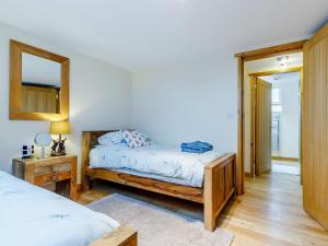 a bedroom with two beds and a mirror at Barn View in Clay Cross