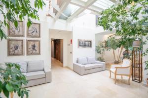 a living room with two couches and trees at Hotel Torres de Somo in Somo