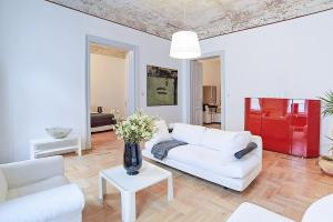 a living room with a white couch and a table at Beautiful apartment in 7th district in Budapest