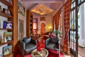 a living room with two chairs and a table at Riad Moucharabieh Matisse in Marrakech