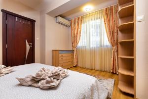 a bedroom with a bed and a window and shelves at Centrally-located 1BD Apartment near Kapana in Plovdiv