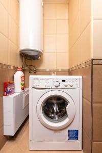 a washer and dryer in a small room at Centrally-located 1BD Apartment near Kapana in Plovdiv