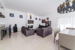 a living room with two couches and a dining table at Villa Eagle Eye Montenegro in Kotor