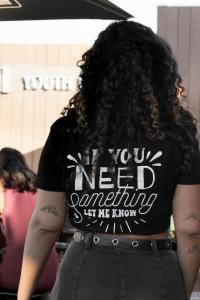 a woman with long curly hair wearing a black shirt at Kabul Party Hostel Barcelona in Barcelona