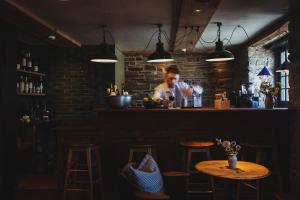 a bar with a picture of a man behind the counter at Albion Aberteifi in Cardigan