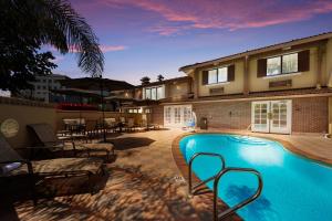 a swimming pool in front of a house at SureStay Plus Hotel by Best Western Mountain View in Mountain View