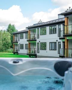 a large white building with balconies in front of it at Suite 110 - Destination Mont-Orford in Magog-Orford