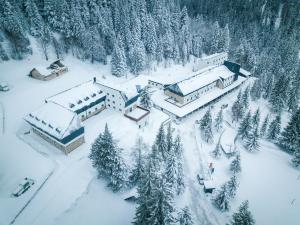 an aerial view of a building covered in snow at Hotel Rajska dolina Jahorina in Jahorina