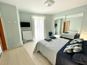 a bedroom with a large bed and a mirror at B&B La finestra sulle Mainarde - Isernia in Isernia