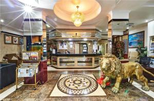 a lobby with a lion statue in the middle of it at West Hotel in Dubai