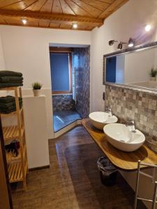 a bathroom with two sinks and a shower at Gästehaus Geist in Ruhpolding