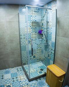 a shower with a glass door in a bathroom at Cozy Apartment in Bakuriani in Bakuriani